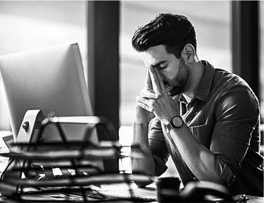 A frustrated man sitting in front of his computer annoyed at getting poor leads from a competing solar leads company.
